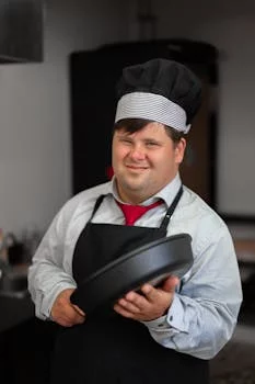 professional male chef smiling kitchen uniform